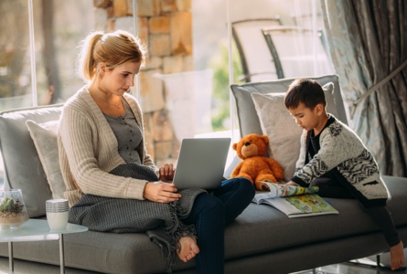 young boy plays quietly while mom works from home
