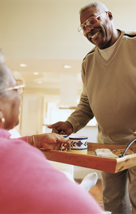 man bringing mother a tray of food